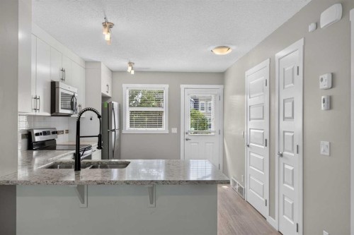 75 Auburn Bay Street Se, Calgary, AB - Indoor Photo Showing Kitchen With Double Sink With Upgraded Kitchen