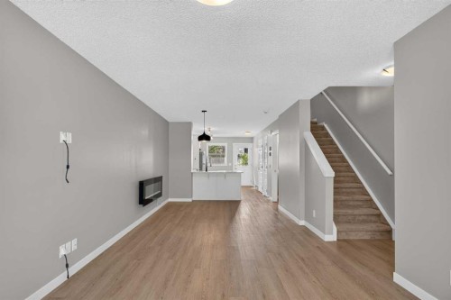 75 Auburn Bay Street Se, Calgary, AB - Indoor Photo Showing Other Room With Fireplace