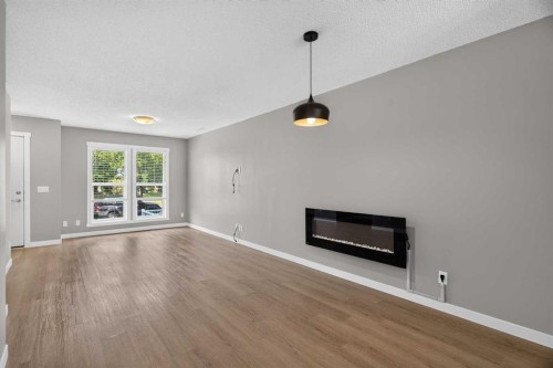 75 Auburn Bay Street Se, Calgary, AB - Indoor Photo Showing Living Room With Fireplace