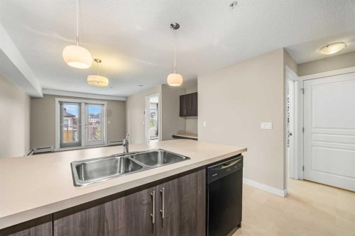 212-2300 Evanston Square Nw, Calgary, AB - Indoor Photo Showing Kitchen With Double Sink