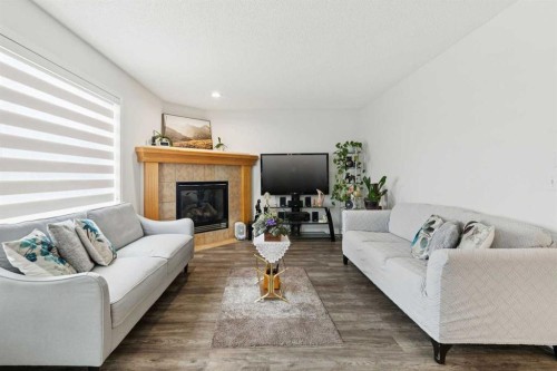 126 Somerglen Way Sw, Calgary, AB - Indoor Photo Showing Living Room With Fireplace