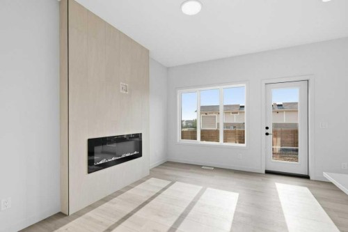 30 Heritage Heath, Cochrane, AB - Indoor Photo Showing Other Room With Fireplace
