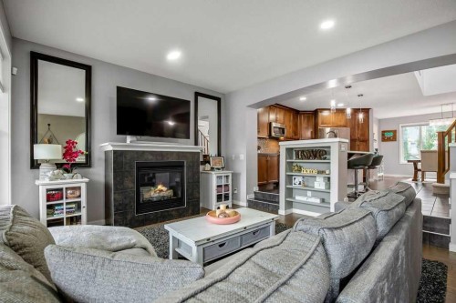 81 New Brighton Heights Se, Calgary, AB - Indoor Photo Showing Living Room With Fireplace