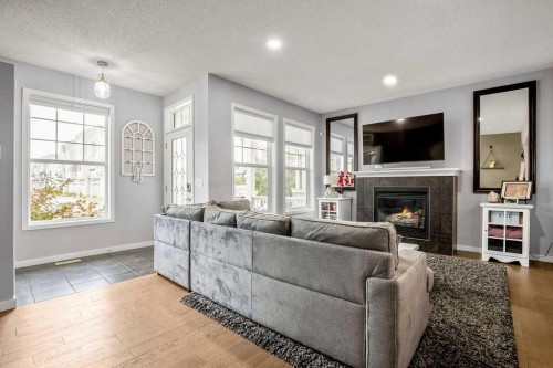 81 New Brighton Heights Se, Calgary, AB - Indoor Photo Showing Living Room With Fireplace