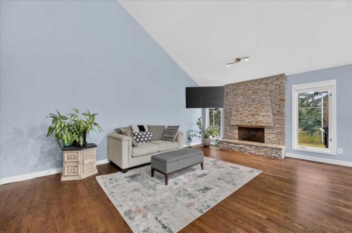 876 Shawnee Drive Sw, Calgary, AB - Indoor Photo Showing Living Room With Fireplace