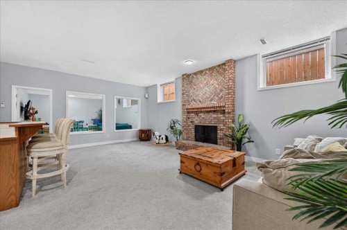 876 Shawnee Drive Sw, Calgary, AB - Indoor Photo Showing Other Room With Fireplace