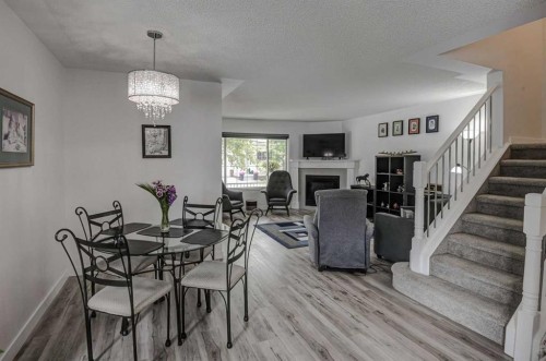 58 Sierra Morena Gardens Sw, Calgary, AB - Indoor Photo Showing Dining Room With Fireplace