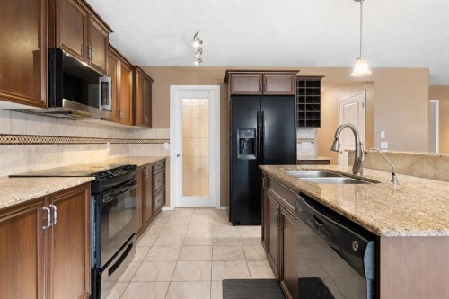 19 Silverado Skies Bay Sw, Calgary, AB - Indoor Photo Showing Kitchen With Double Sink