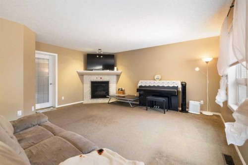 19 Silverado Skies Bay Sw, Calgary, AB - Indoor Photo Showing Living Room With Fireplace