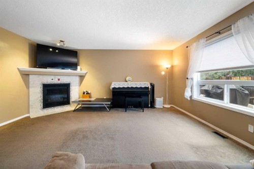 19 Silverado Skies Bay Sw, Calgary, AB - Indoor Photo Showing Living Room With Fireplace