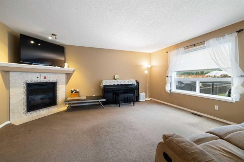 19 Silverado Skies Bay Sw, Calgary, AB - Indoor Photo Showing Living Room With Fireplace