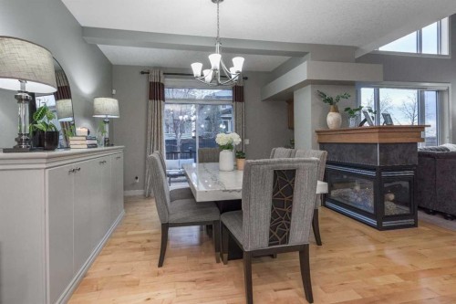 76 Evanspark Circle Nw, Calgary, AB - Indoor Photo Showing Dining Room With Fireplace