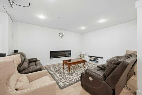 160 Panatella Crescent Nw, Calgary, AB - Indoor Photo Showing Other Room With Fireplace