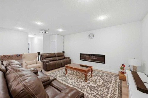 160 Panatella Crescent Nw, Calgary, AB - Indoor Photo Showing Living Room With Fireplace