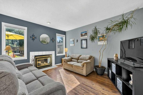83 Millrise Crescent Sw, Calgary, AB - Indoor Photo Showing Living Room With Fireplace