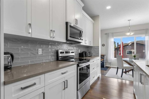 111 Hillcrest Close Sw, Airdrie, AB - Indoor Photo Showing Kitchen With Stainless Steel Kitchen With Upgraded Kitchen