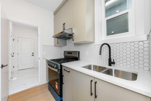 503 Rivercrest View, Cochrane, AB - Indoor Photo Showing Kitchen With Double Sink