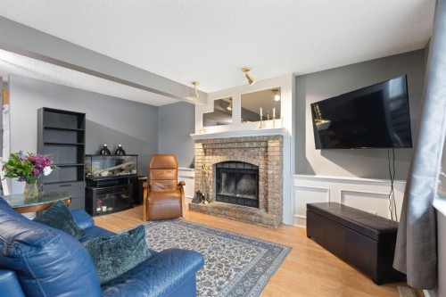 176 Riverbend Drive Se, Calgary, AB - Indoor Photo Showing Living Room With Fireplace