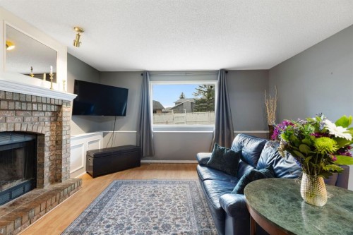 176 Riverbend Drive Se, Calgary, AB - Indoor Photo Showing Living Room With Fireplace