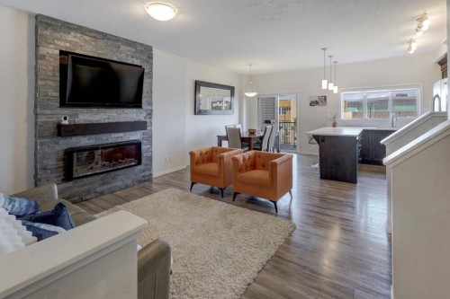 673 Hillcrest Road Sw, Airdrie, AB - Indoor Photo Showing Living Room With Fireplace