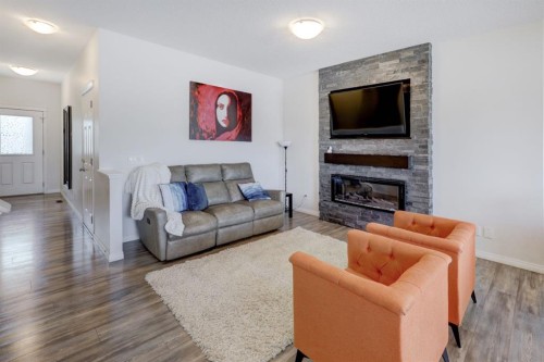 673 Hillcrest Road Sw, Airdrie, AB - Indoor Photo Showing Living Room With Fireplace