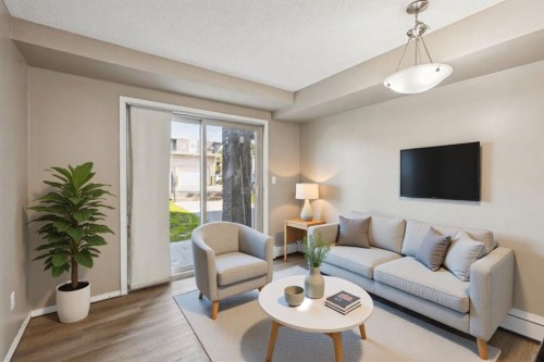 2117-403 Mackenzie Way Sw, Airdrie, AB - Indoor Photo Showing Living Room