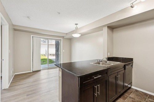 2117-403 Mackenzie Way Sw, Airdrie, AB - Indoor Photo Showing Kitchen With Double Sink