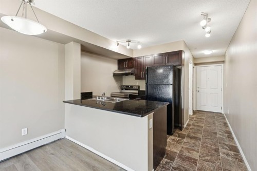 2117-403 Mackenzie Way Sw, Airdrie, AB - Indoor Photo Showing Kitchen With Double Sink