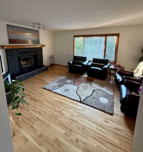 151 Riverside Mews Se, Calgary, AB - Indoor Photo Showing Living Room With Fireplace