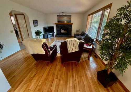 151 Riverside Mews Se, Calgary, AB - Indoor Photo Showing Other Room With Fireplace