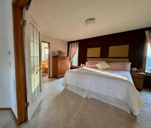 151 Riverside Mews Se, Calgary, AB - Indoor Photo Showing Bedroom