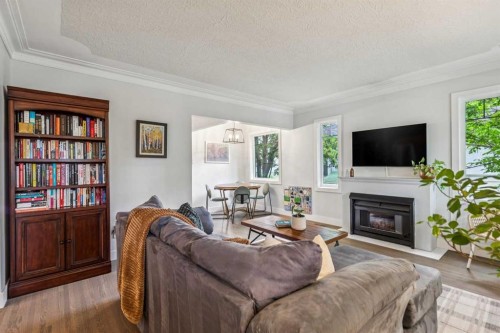 1644 16 Street Se, Calgary, AB - Indoor Photo Showing Living Room With Fireplace