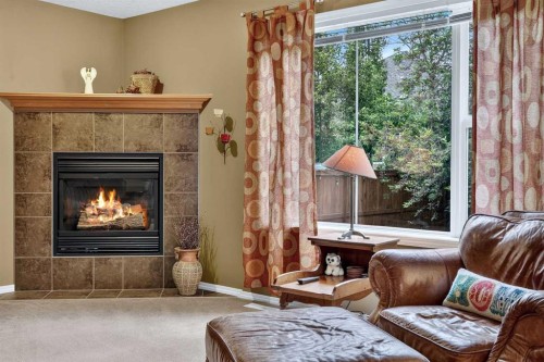14 Evergreen Common Sw, Calgary, AB - Indoor Photo Showing Living Room With Fireplace