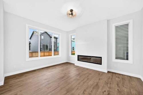 583 Buffaloberry Manor Se, Calgary, AB - Indoor Photo Showing Other Room With Fireplace