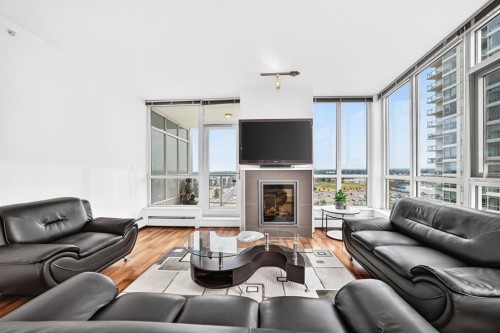 1405-99 Spruce Place Sw, Calgary, AB - Indoor Photo Showing Living Room With Fireplace