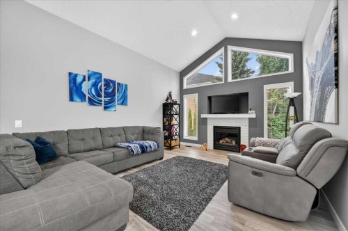 212 Cresthaven Place Sw, Calgary, AB - Indoor Photo Showing Living Room With Fireplace