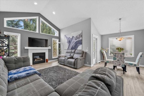 212 Cresthaven Place Sw, Calgary, AB - Indoor Photo Showing Living Room With Fireplace