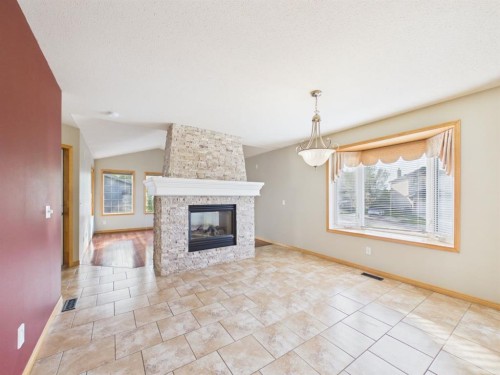 181 Panamount Hill Nw, Calgary, AB - Indoor Photo Showing Living Room With Fireplace