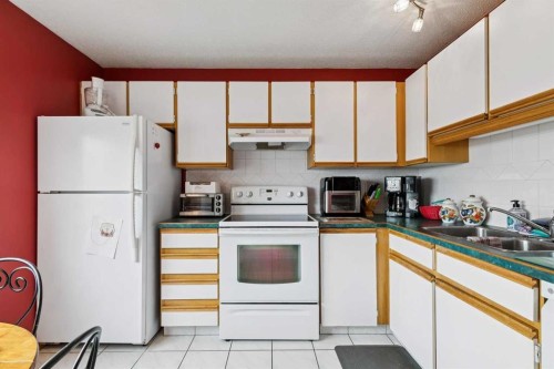 316 Queenston Heights Se, Calgary, AB - Indoor Photo Showing Kitchen With Double Sink