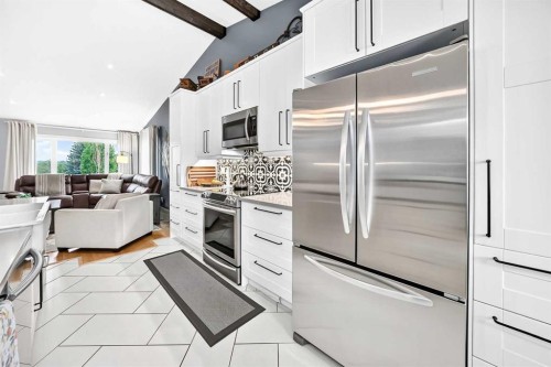 61 West Edge Road, Cochrane, AB - Indoor Photo Showing Kitchen With Upgraded Kitchen