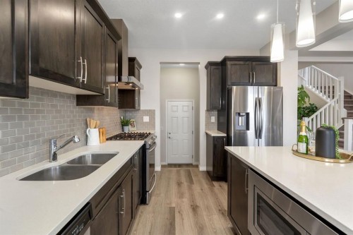 121 Osborne Common Sw, Airdrie, AB - Indoor Photo Showing Kitchen With Double Sink With Upgraded Kitchen