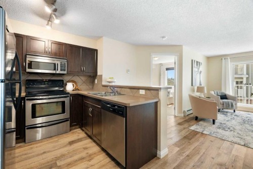 5209-69 Country Village Manor Ne, Calgary, AB - Indoor Photo Showing Kitchen With Stainless Steel Kitchen With Double Sink