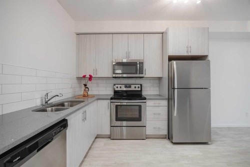 4309-215 Legacy Boulevard Se, Calgary, AB - Indoor Photo Showing Kitchen With Stainless Steel Kitchen With Double Sink