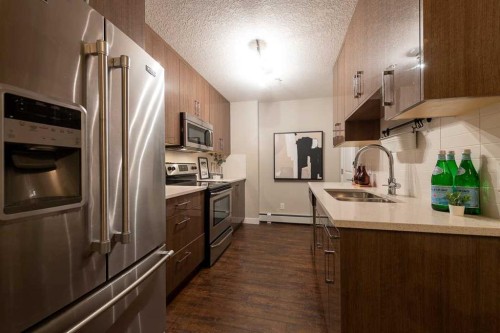403-607 17 Avenue Nw, Calgary, AB - Indoor Photo Showing Kitchen With Stainless Steel Kitchen With Double Sink With Upgraded Kitchen