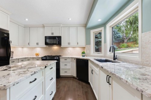 311 Woodhaven Bay Sw, Calgary, AB - Indoor Photo Showing Kitchen With Upgraded Kitchen