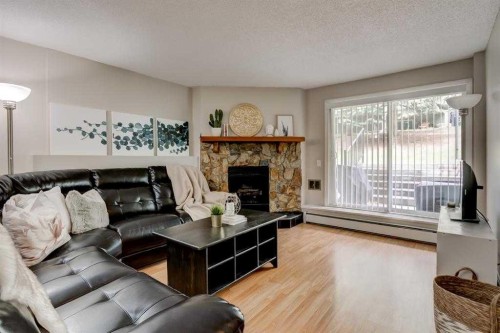 2135-70 Glamis Drive Sw, Calgary, AB - Indoor Photo Showing Living Room With Fireplace