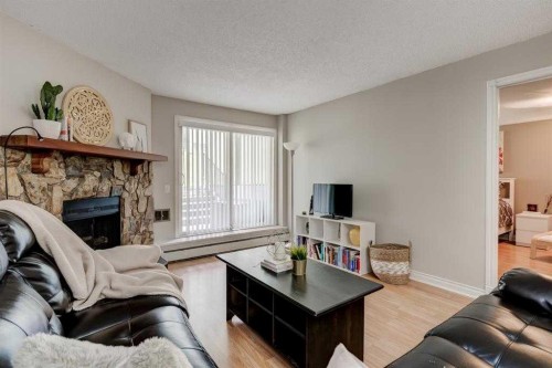 2135-70 Glamis Drive Sw, Calgary, AB - Indoor Photo Showing Living Room With Fireplace