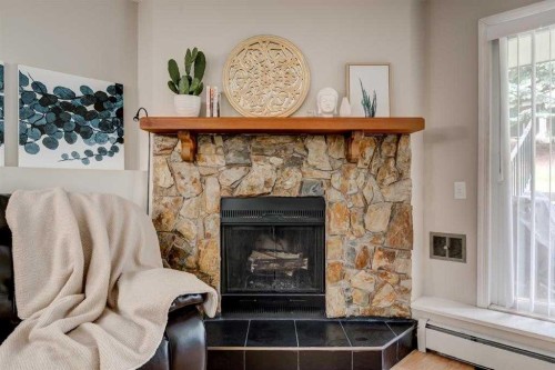2135-70 Glamis Drive Sw, Calgary, AB - Indoor Photo Showing Living Room With Fireplace