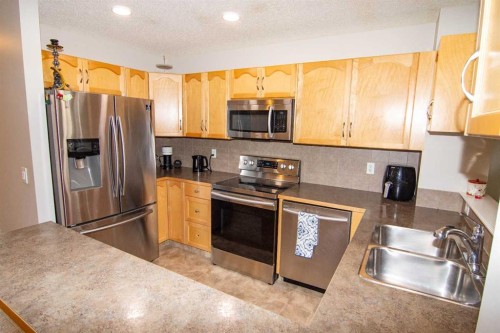754 Luxstone Gate Sw, Airdrie, AB - Indoor Photo Showing Kitchen With Double Sink