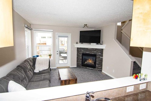 754 Luxstone Gate Sw, Airdrie, AB - Indoor Photo Showing Living Room With Fireplace